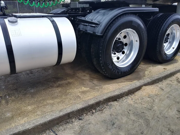 Fuel tank and wheels on a semi tractor unit after a wash