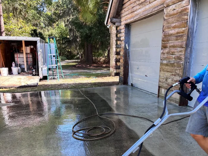 Concrete apron in front of a garage being pressure washed