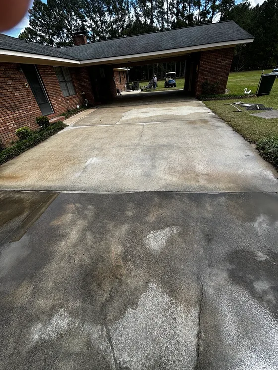 Driveway part way through cleaning, clean and dirty concrete side by side