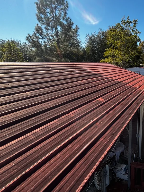 Red metal roof cleaned down along the ridge