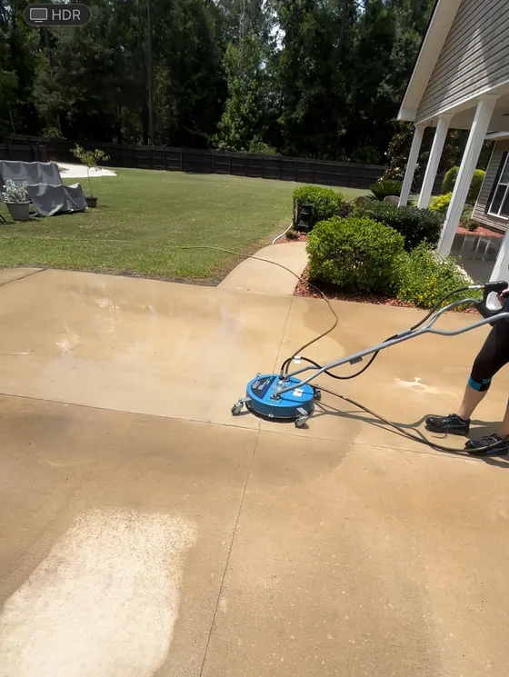 Surface cleaner being run down a concrete driveway