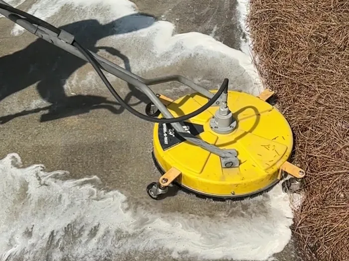 Surface cleaner head working across concrete