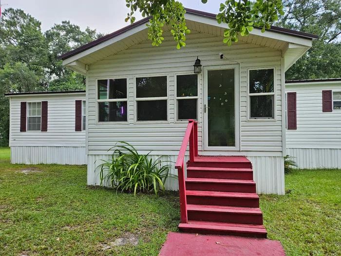 Home with clean siding, porch and painted steps
